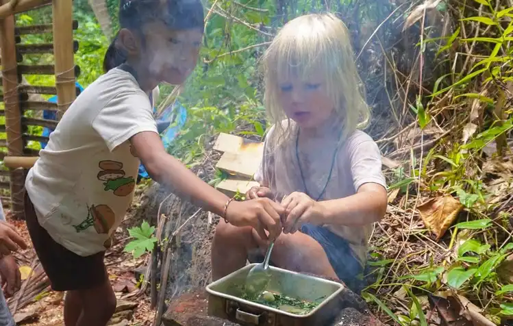 kids cook together at backyard